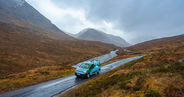 Scottish Water van on the main road through Glencoe with snowy mountain backdrop