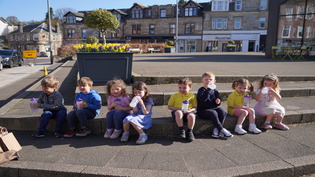 Children sitting on steps drinking water from Top Up Tap