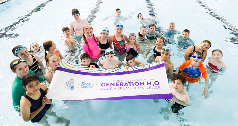 Children in a pool holding a Generation H2O sign