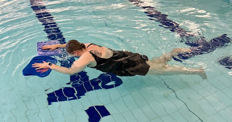 Laura McLeod floating face down in swimming pool with hand float aids