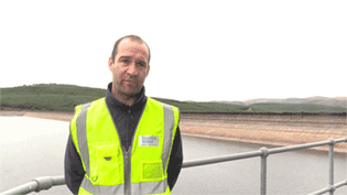 man in hi vis at a reservoir