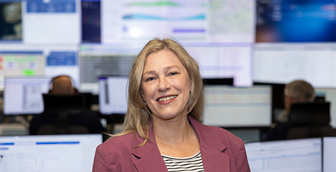 Acting Cabinet Secretary for Net Zero and Energy in the Intelligent Network Control Room with bank of digital screens