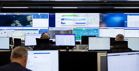 banks of digital screens in the control room at Scottish Water with some staff at their desks